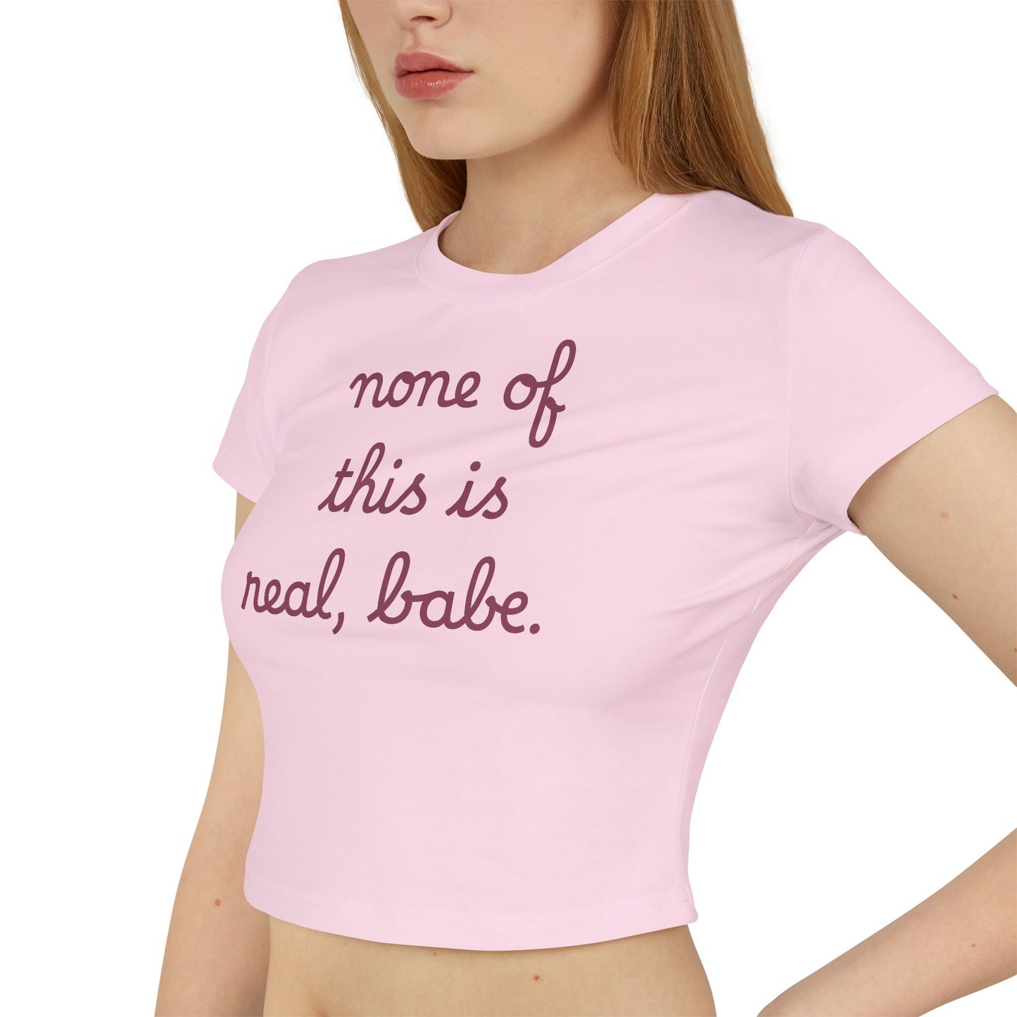 Baby Tee — "none of this is real, babe." Cropped Graphic Tee