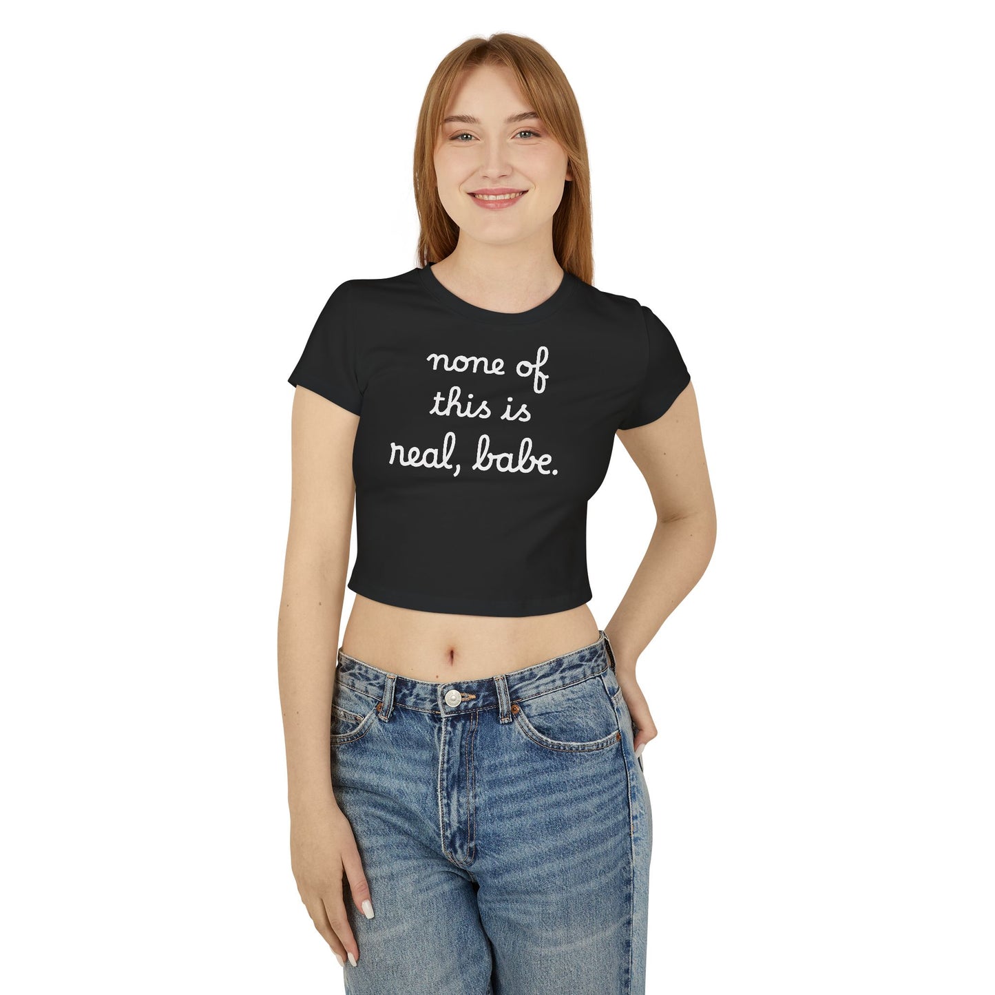 Baby Tee — "none of this is real, babe." Cropped Graphic Tee