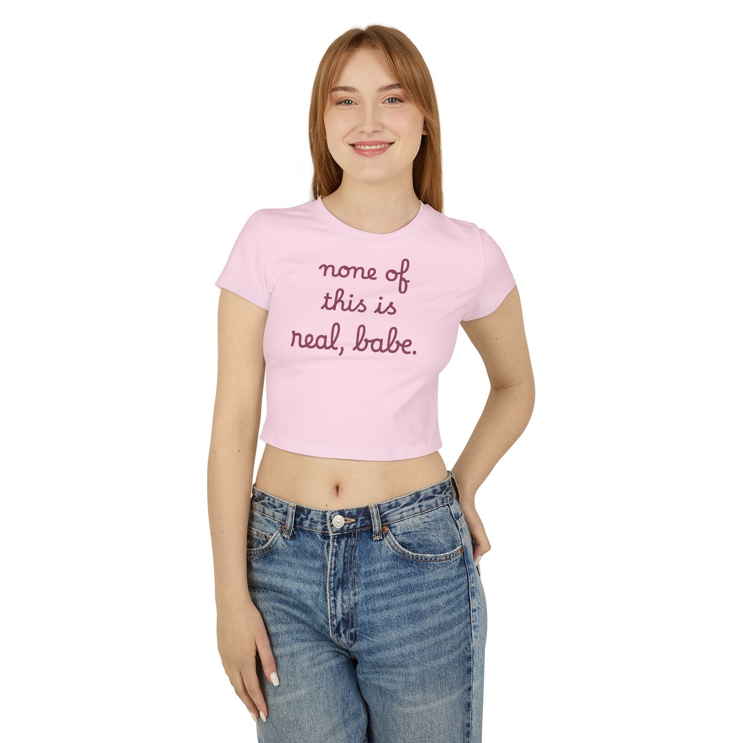 Baby Tee — "none of this is real, babe." Cropped Graphic Tee