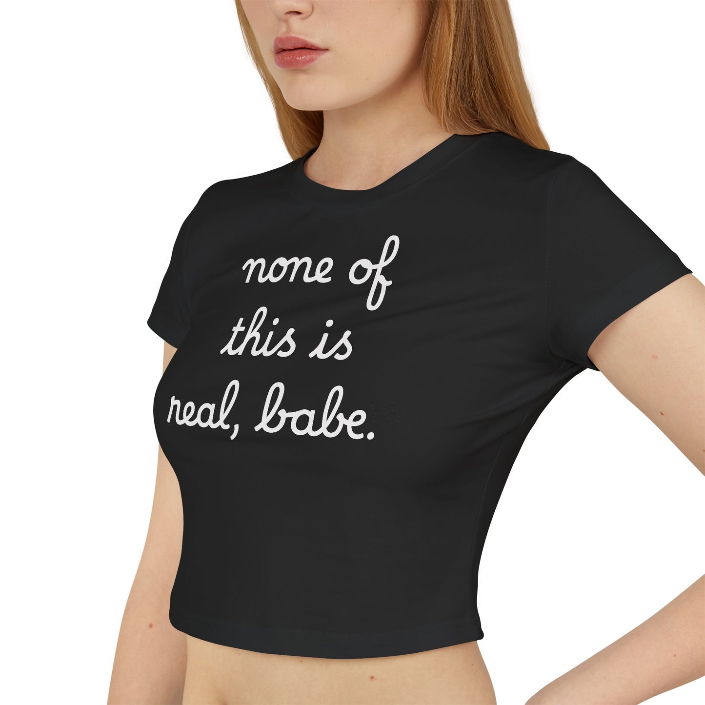 Baby Tee — "none of this is real, babe." Cropped Graphic Tee
